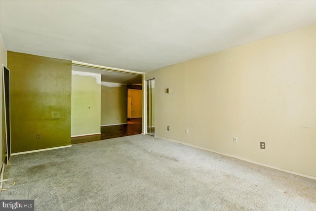 empty room with carpet flooring and baseboards
