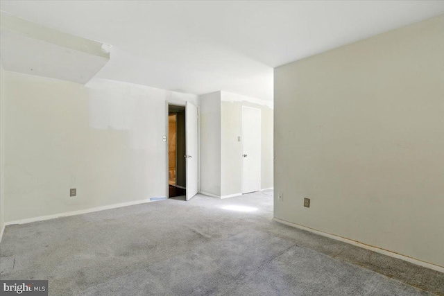 carpeted empty room with baseboards