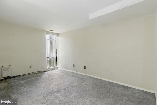 carpeted empty room with baseboards