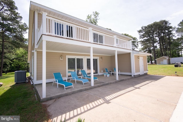 5470 Moose Lodge Rd, Cambridge, MD 21613 - rear view of house with a balcony, a patio, and a yard
