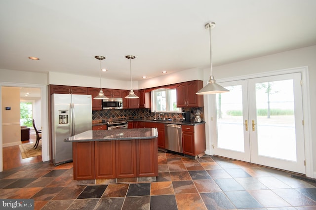 5470 Moose Lodge Rd, Cambridge, MD 21613 - kitchen with appliances with stainless steel finishes, tasteful backsplash, healthy amount of natural light, a center island, and recessed lighting