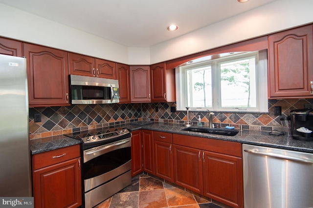 5470 Moose Lodge Rd, Cambridge, MD 21613 - kitchen with appliances with stainless steel finishes, backsplash, dark stone counters, recessed lighting, and dark stone finish floors