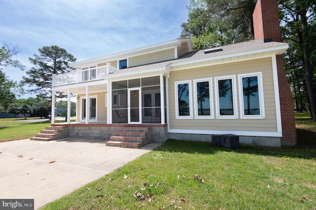 5470 Moose Lodge Rd, Cambridge, MD 21613 - back of property with a yard, a sunroom, a balcony, roof with shingles, and a chimney