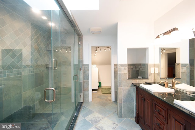 5470 Moose Lodge Rd, Cambridge, MD 21613 - bathroom featuring double vanity, a shower stall, tile walls, and a wainscoted wall