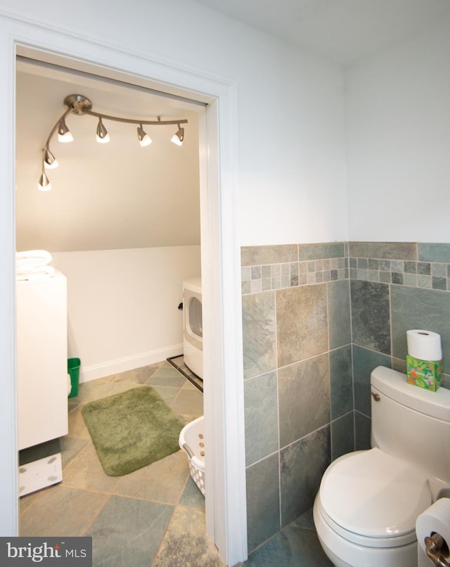 5470 Moose Lodge Rd, Cambridge, MD 21613 - bathroom with separate washer and dryer, tile walls, and tile patterned floors