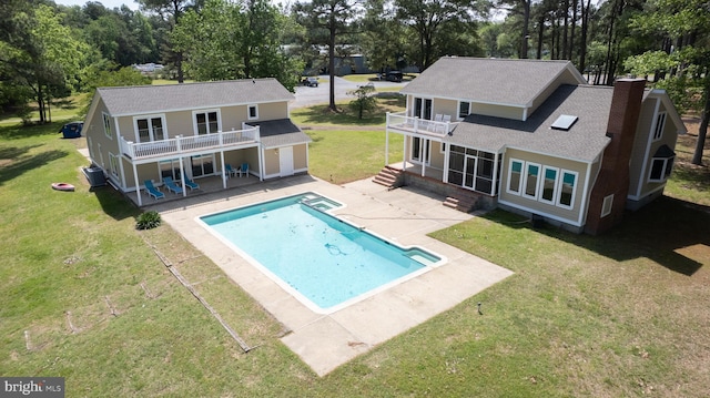 5470 Moose Lodge Rd, Cambridge, MD 21613 - back of house featuring a balcony, a patio area, roof with shingles, a yard, and a pool with connected hot tub