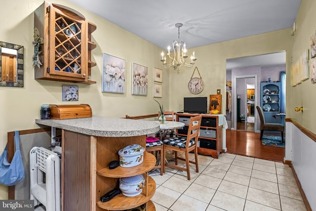 2054 Harbour Dr, Palmyra, NJ 08065 - kitchen with open shelves, a chandelier, light countertops, light tile patterned flooring, and a peninsula
