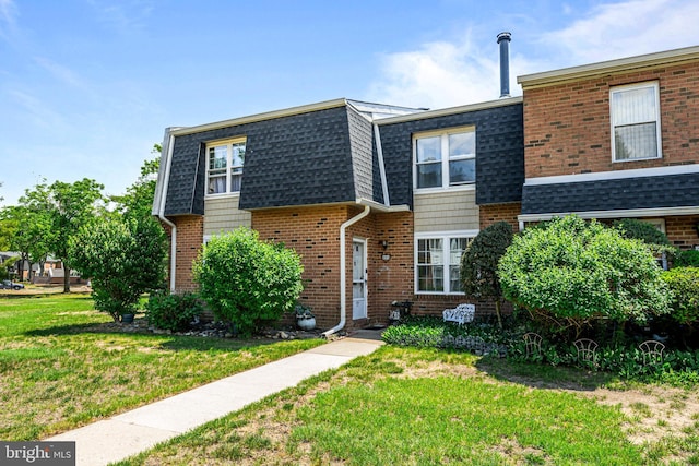 2054 Harbour Dr, Palmyra, NJ 08065 - view of front of house with a shingled roof, a front lawn, brick siding, and mansard roof