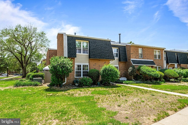 2054 Harbour Dr, Palmyra, NJ 08065 - view of front of home featuring brick siding, mansard roof, a front yard, and roof with shingles