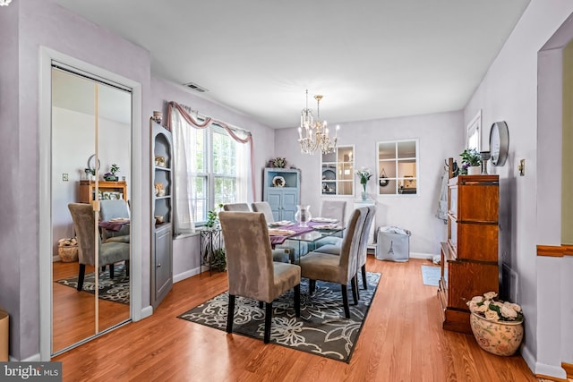 2054 Harbour Dr, Palmyra, NJ 08065 - dining space with wood finished floors, a chandelier, and baseboards
