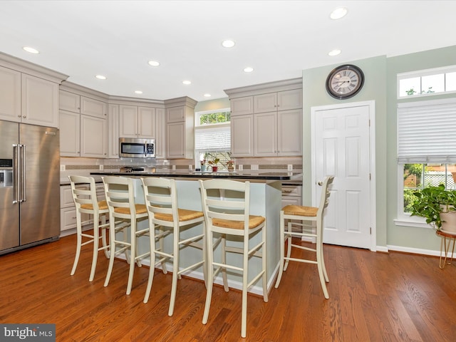 6470 Saddlebrook Ln, Frederick, MD 21701 - kitchen with appliances with stainless steel finishes, decorative backsplash, gray cabinets, dark countertops, and a breakfast bar