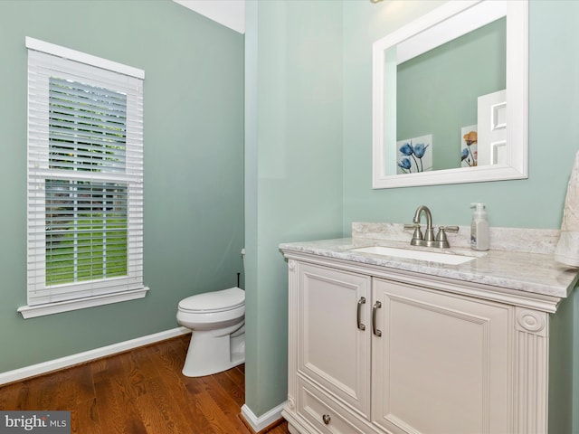 6470 Saddlebrook Ln, Frederick, MD 21701 - bathroom with wood finished floors, toilet, vanity, and baseboards