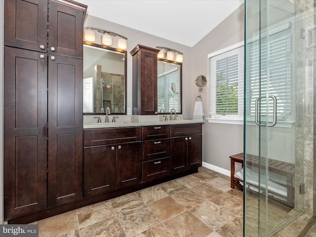 6470 Saddlebrook Ln, Frederick, MD 21701 - bathroom featuring a shower stall, baseboards, double vanity, vaulted ceiling, and stone finish floors