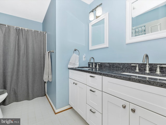 6470 Saddlebrook Ln, Frederick, MD 21701 - bathroom featuring baseboards, double vanity, tile patterned floors, and toilet