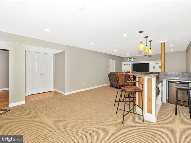 6470 Saddlebrook Ln, Frederick, MD 21701 - kitchen featuring light colored carpet, a breakfast bar area, decorative light fixtures, open floor plan, and baseboards