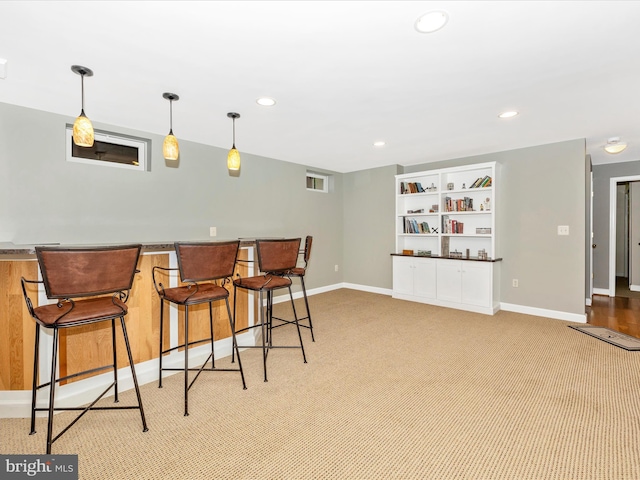 6470 Saddlebrook Ln, Frederick, MD 21701 - kitchen with baseboards, recessed lighting, a breakfast bar area, light colored carpet, and hanging light fixtures