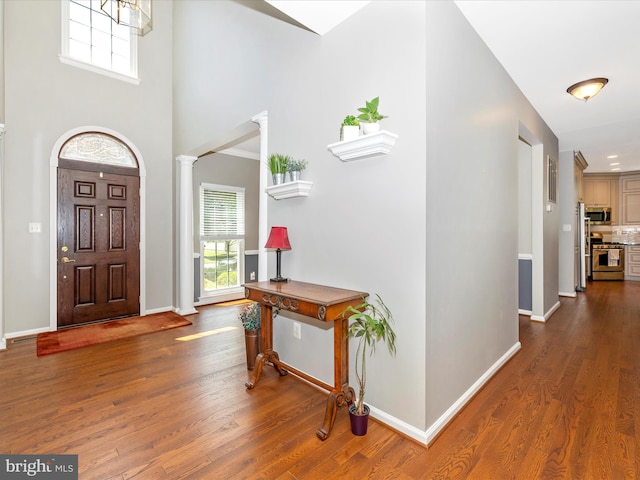 6470 Saddlebrook Ln, Frederick, MD 21701 - entryway featuring ornate columns, dark wood-style floors, baseboards, and a towering ceiling