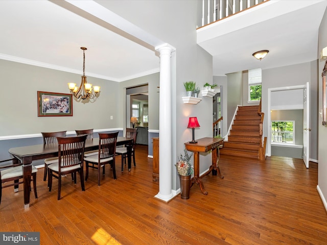 6470 Saddlebrook Ln, Frederick, MD 21701 - dining room featuring wood finished floors, baseboards, decorative columns, a chandelier, and stairs