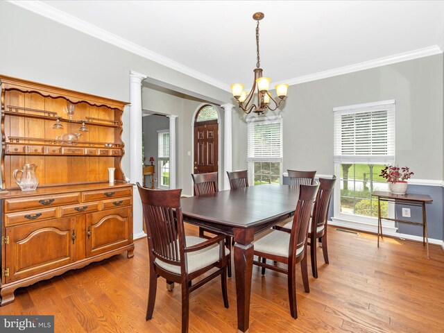 6470 Saddlebrook Ln, Frederick, MD 21701 - dining room with a chandelier, ornamental molding, light wood finished floors, ornate columns, and baseboards