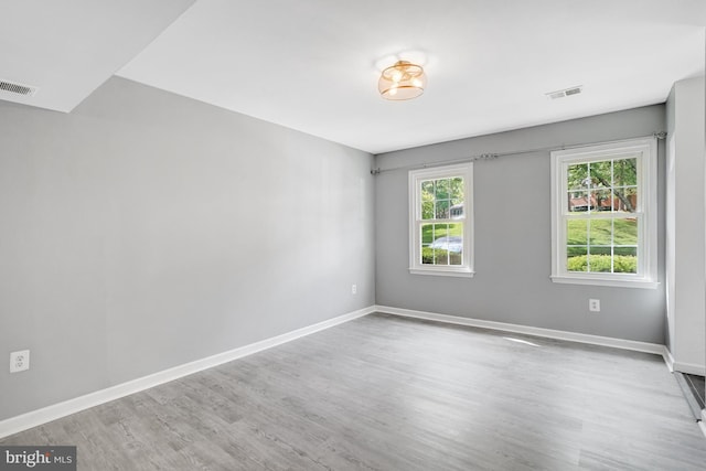 empty room featuring wood finished floors and baseboards
