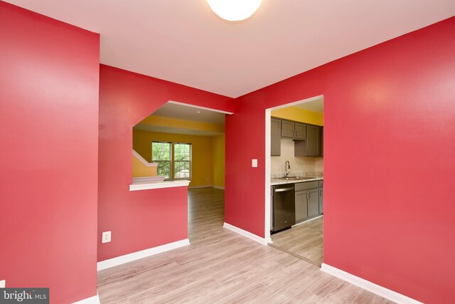 10305 Butternut Cir, Manassas, VA 20110 - corridor featuring a sink, light wood-style floors, and baseboards