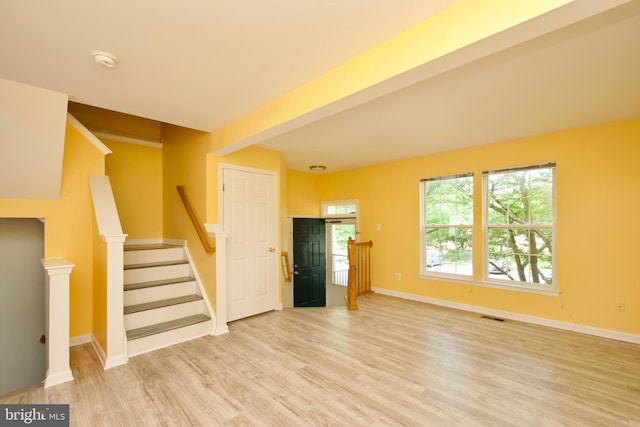 10305 Butternut Cir, Manassas, VA 20110 - unfurnished living room featuring light wood finished floors, baseboards, and stairway