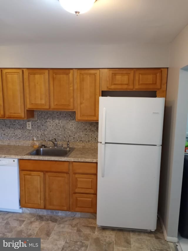 28 Ridgewood Pl, Willingboro, NJ 08046 - kitchen featuring white appliances, a sink, brown cabinets, light countertops, and tasteful backsplash
