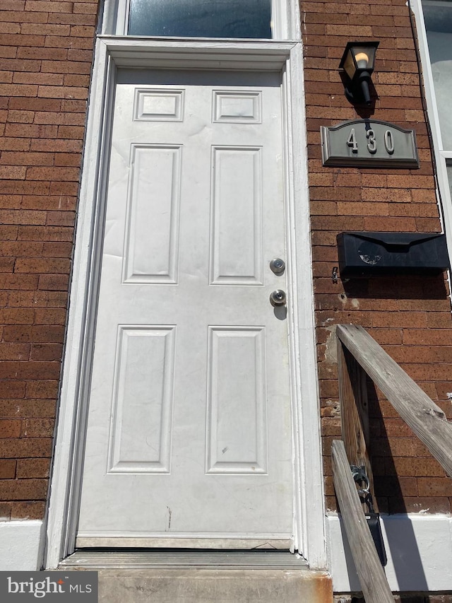 entrance to property with brick siding
