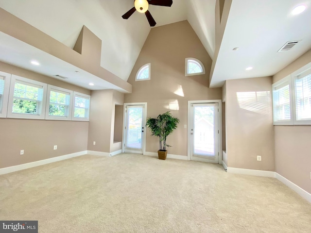 empty room featuring a ceiling fan, light carpet, baseboards, high vaulted ceiling, and recessed lighting