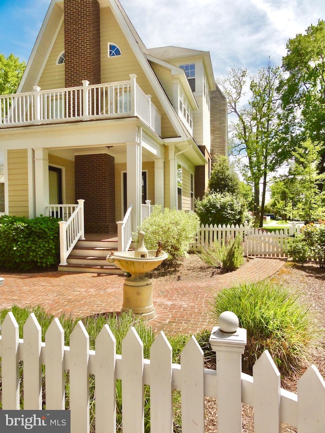 view of front of home featuring covered porch and a balcony