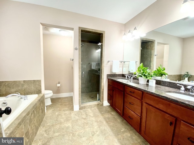 full bathroom with a stall shower, a garden tub, double vanity, toilet, and baseboards