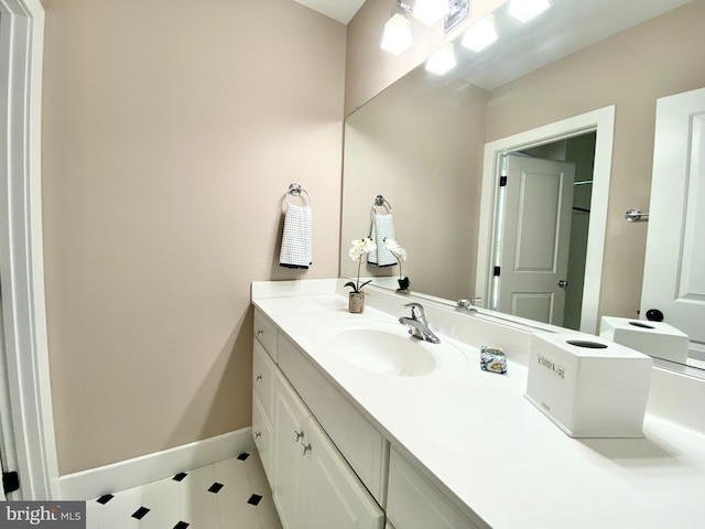 bathroom with baseboards, vanity, and tile patterned floors