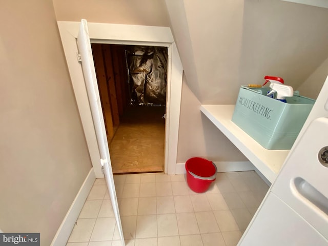 laundry room with tile patterned floors and baseboards