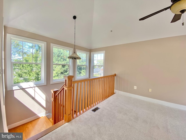 corridor featuring an upstairs landing, baseboards, vaulted ceiling, and carpet