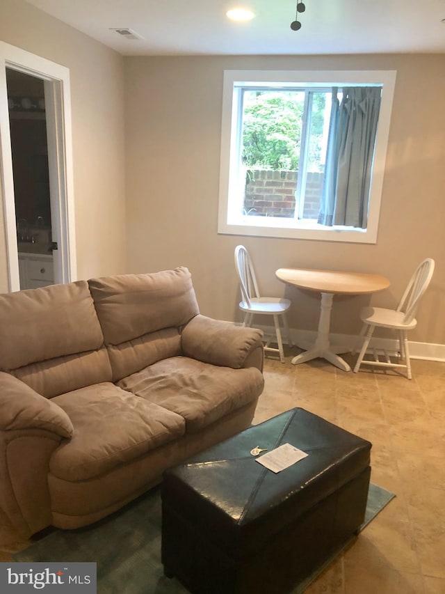 living room featuring baseboards and recessed lighting