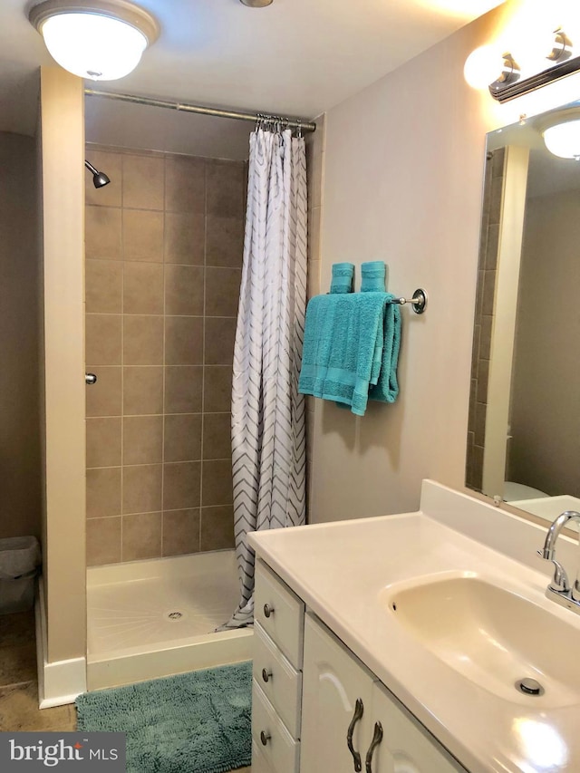 bathroom featuring vanity, a stall shower, and tile patterned flooring