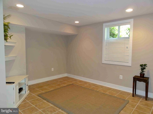 below grade area featuring light tile patterned floors, recessed lighting, and baseboards