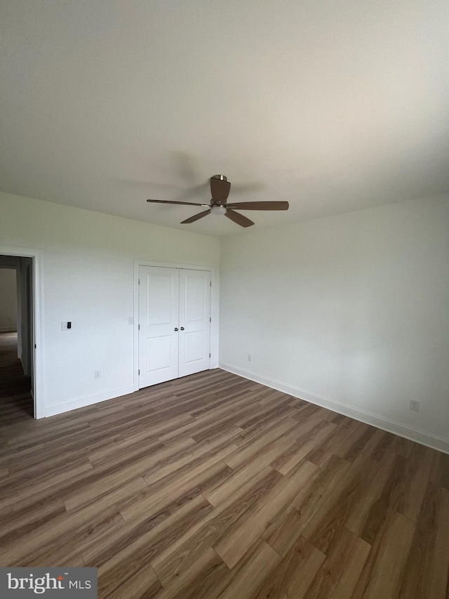 607 Slonaker Ln, Martinsburg, WV 25405 - unfurnished bedroom with wood finished floors, a closet, and a ceiling fan