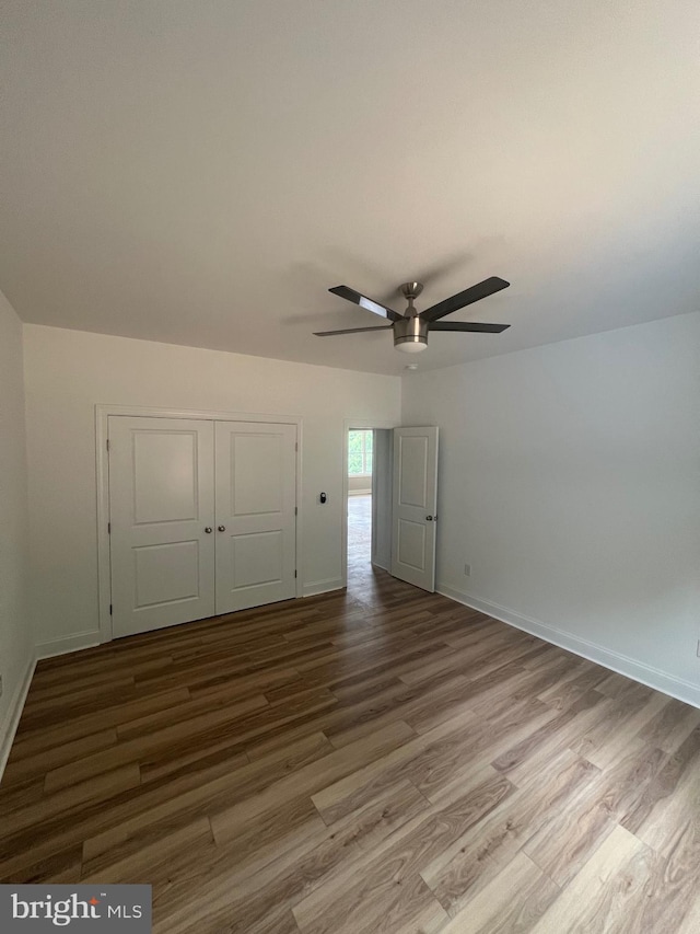607 Slonaker Ln, Martinsburg, WV 25405 - unfurnished bedroom with wood finished floors, a closet, and a ceiling fan