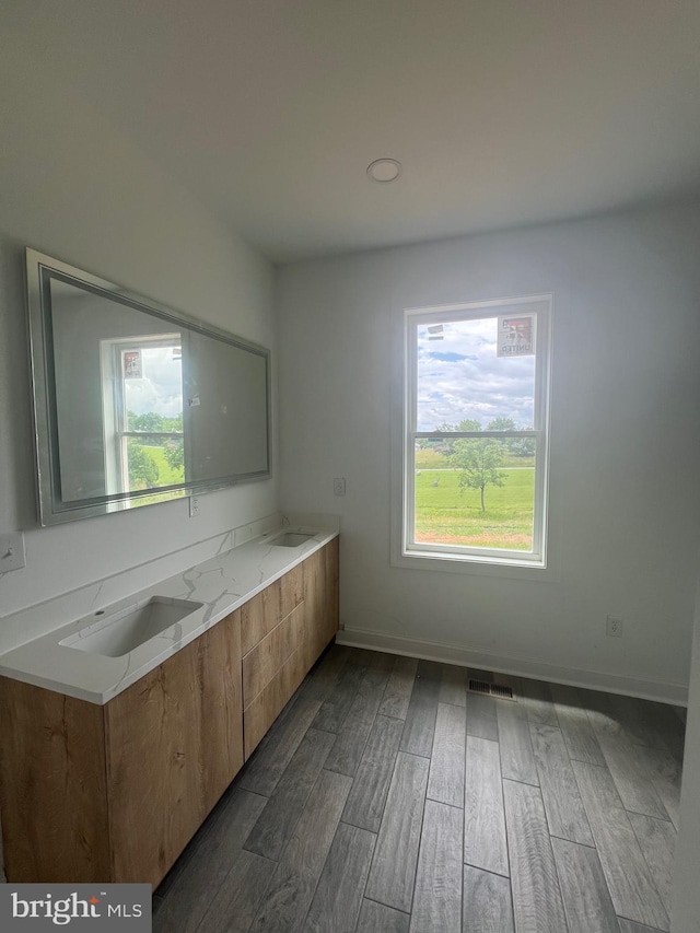 607 Slonaker Ln, Martinsburg, WV 25405 - kitchen featuring healthy amount of natural light, dark wood finished floors, and brown cabinets