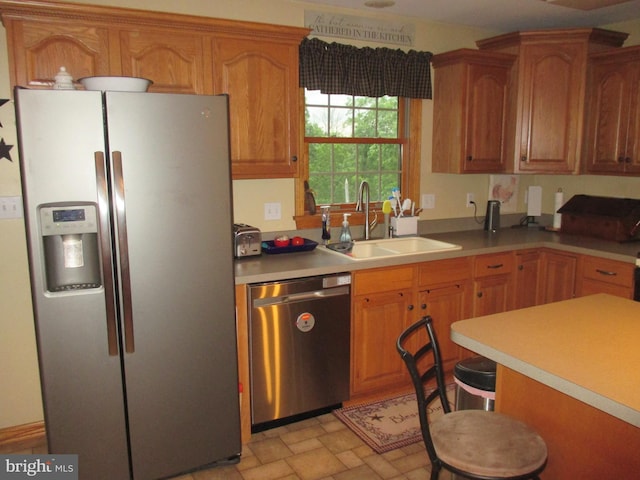 151 Juniper Dr, Ridgeley, WV 26753 - kitchen featuring stainless steel appliances, a sink, light countertops, and brown cabinets