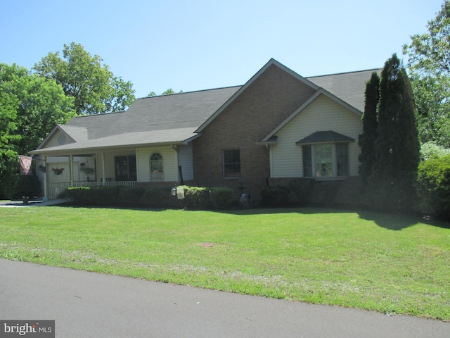 151 Juniper Dr, Ridgeley, WV 26753 - view of front facade with a front lawn, covered porch, and brick siding