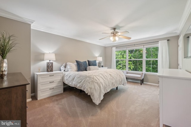 bedroom with light colored carpet, ornamental molding, baseboards, and a ceiling fan
