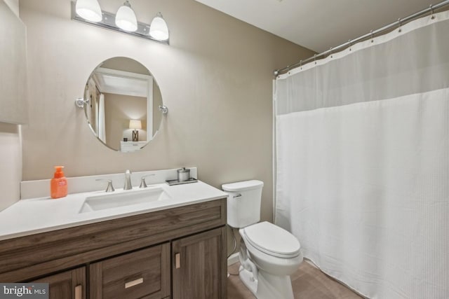 bathroom with toilet, vanity, and tile patterned floors
