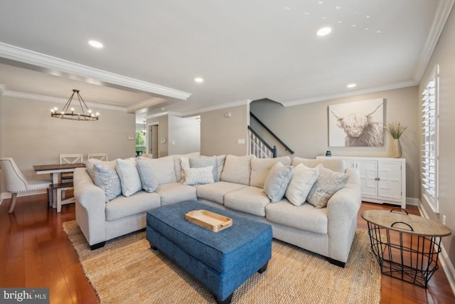 living room featuring wood-type flooring, a chandelier, crown molding, stairs, and recessed lighting
