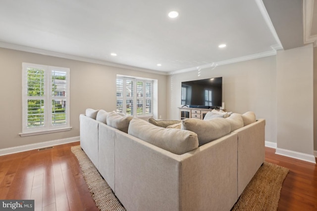 living area featuring ornamental molding, hardwood / wood-style flooring, baseboards, and recessed lighting