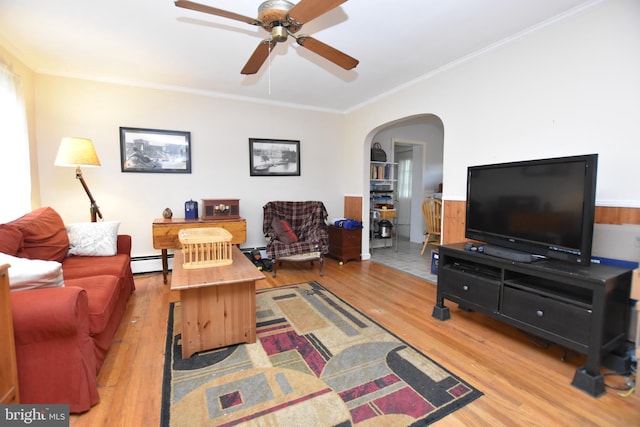 715 Susquehanna Cir, Newark, DE 19711 - living room featuring ornamental molding, wood finished floors, arched walkways, a baseboard radiator, and a ceiling fan