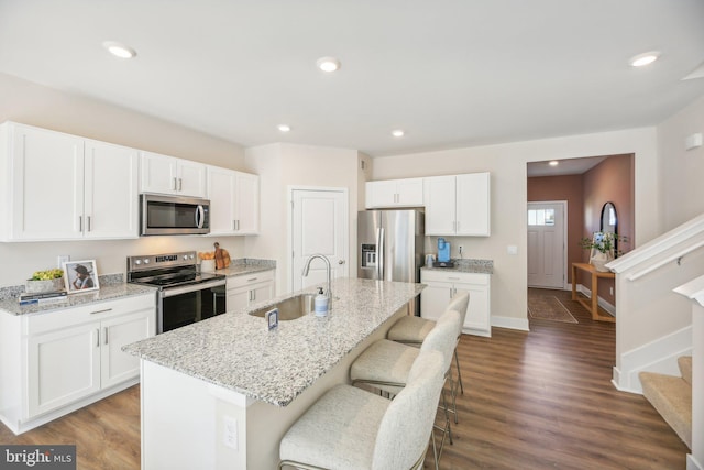 116 Munsee Cir, Winchester, VA 22602 - kitchen with stainless steel appliances, a sink, a kitchen bar, a kitchen island with sink, and white cabinets