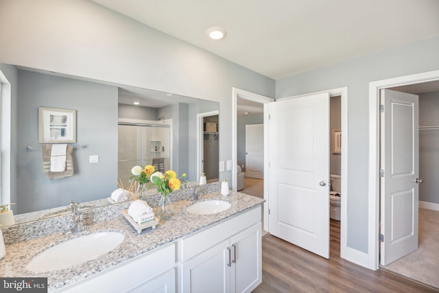 116 Munsee Cir, Winchester, VA 22602 - bathroom featuring a shower stall, toilet, a spacious closet, wood finished floors, and double vanity