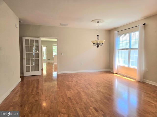 10 Honeyflower, Bordentown, NJ 08620 - spare room featuring a chandelier, wood finished floors, and baseboards